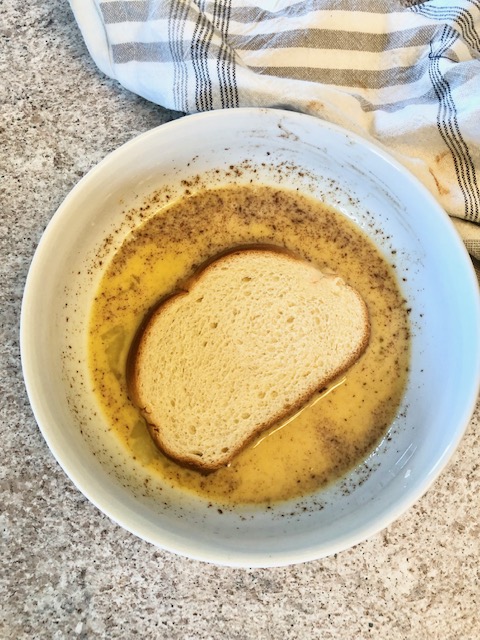 Bread in a bowl of french toast mix
