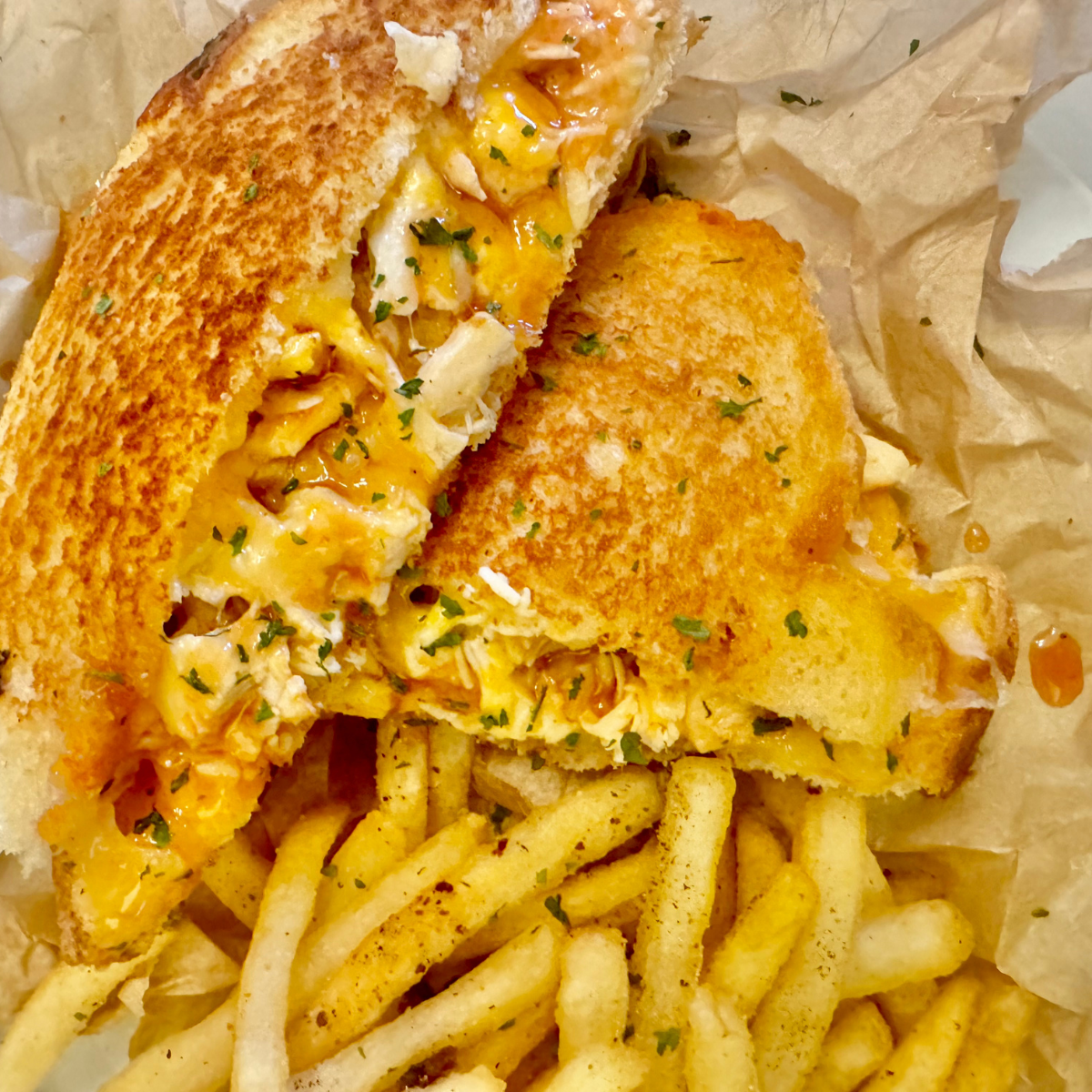 Buffalo Chicken Grilled Cheese on a bed of French fries