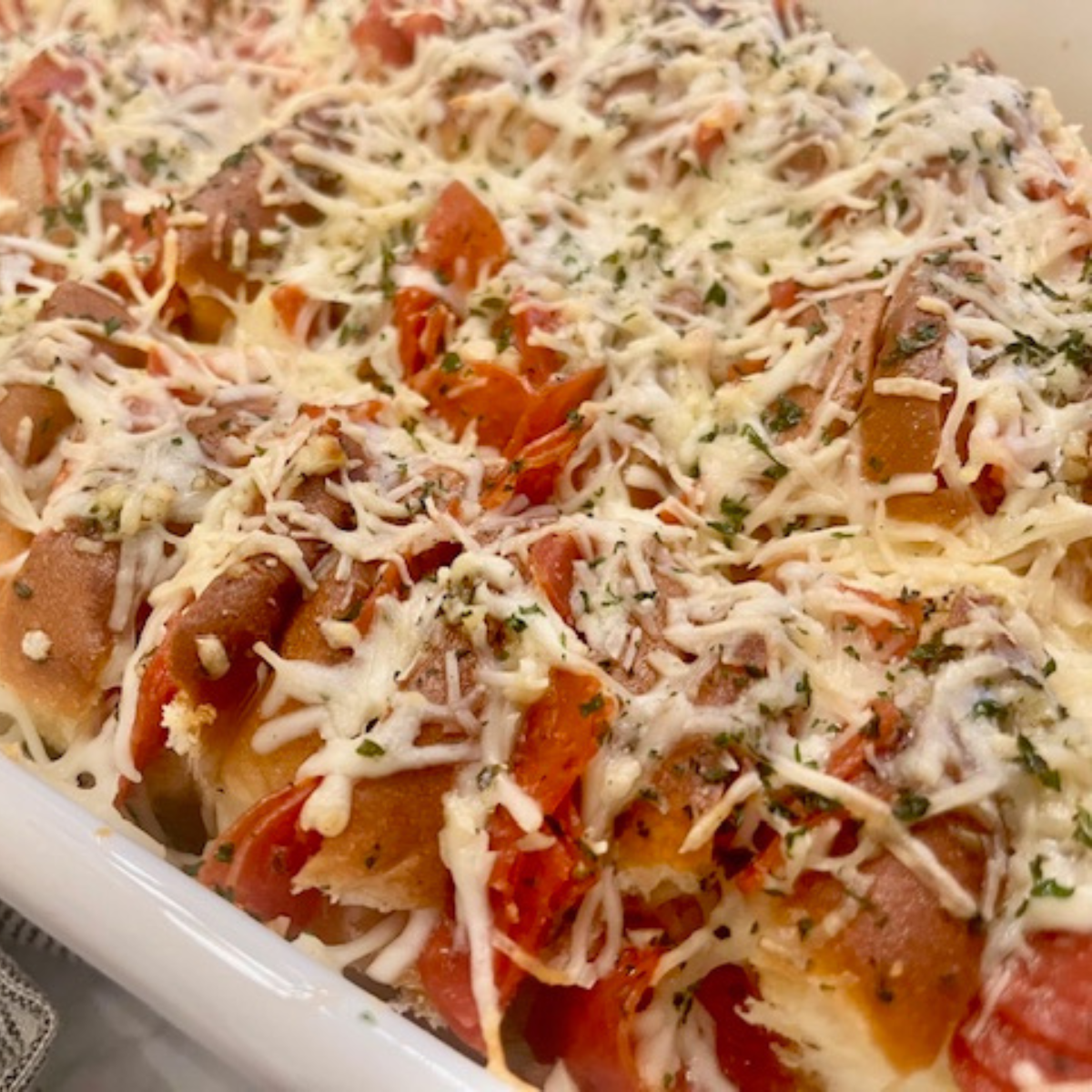 Close up image of baked Hawaiian Roll Pizza Sliders