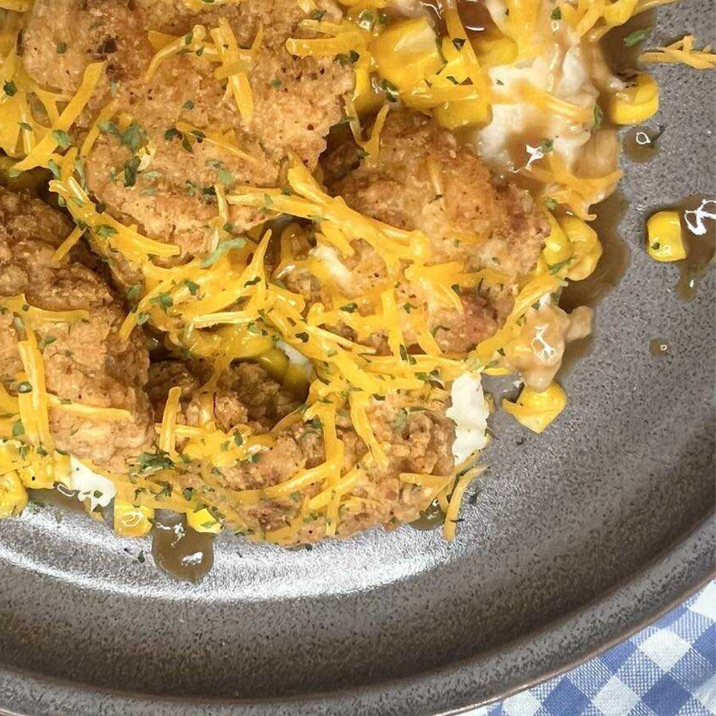 Close up image of a KFC Bowl with a gingham napkin
