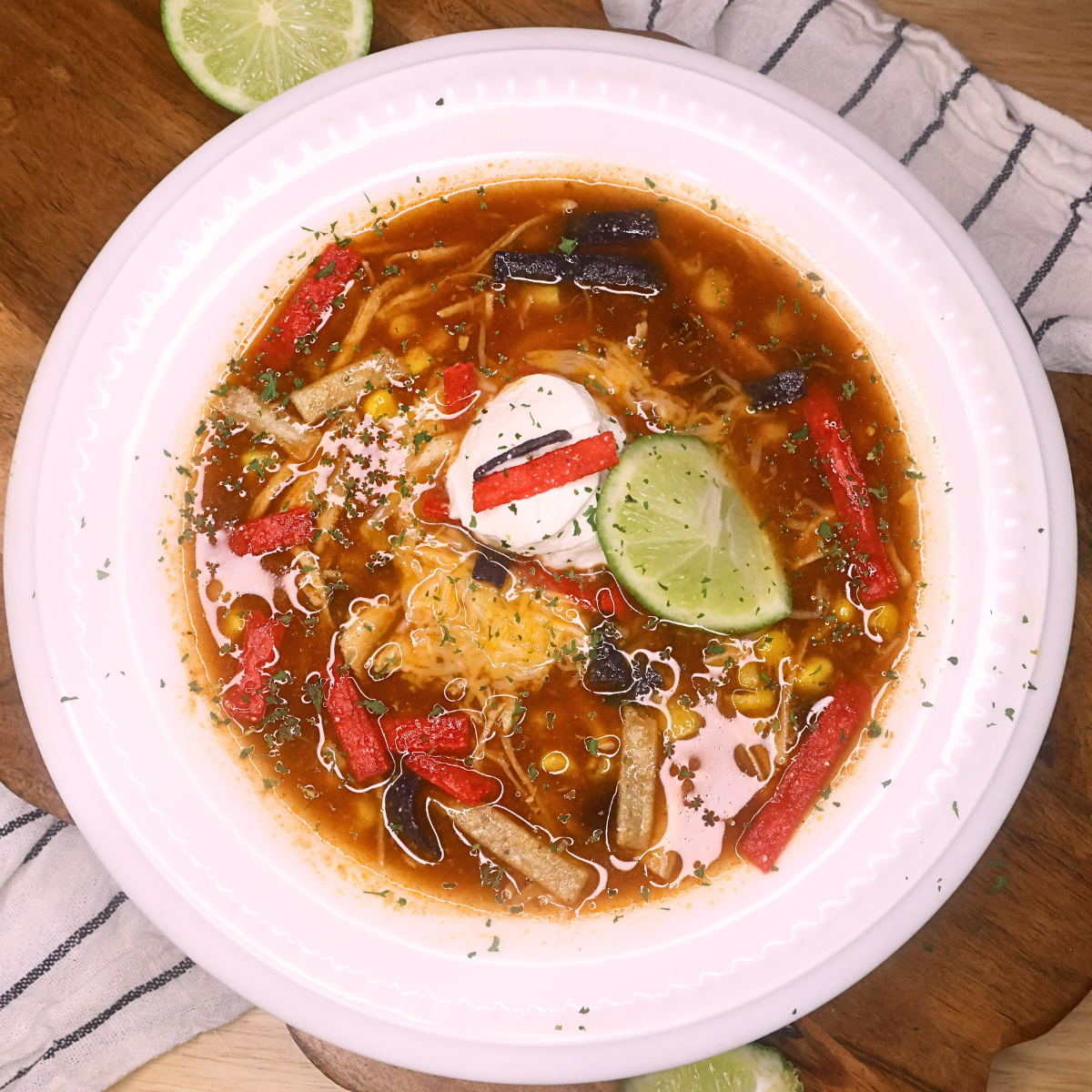 Overhead image of slow cooker chicken tortilla soup in a white bowl