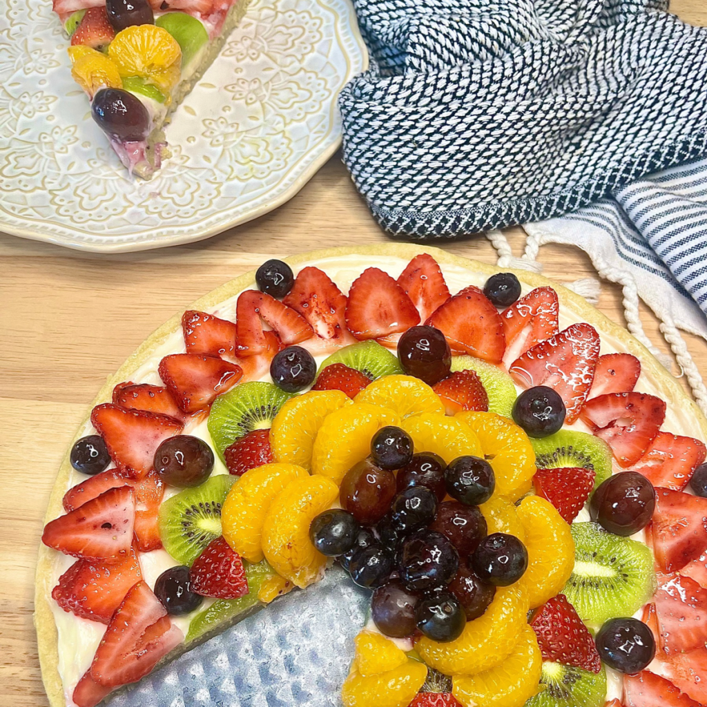 Sugar Cookie and Fruit Pizza with a slice cut out of it