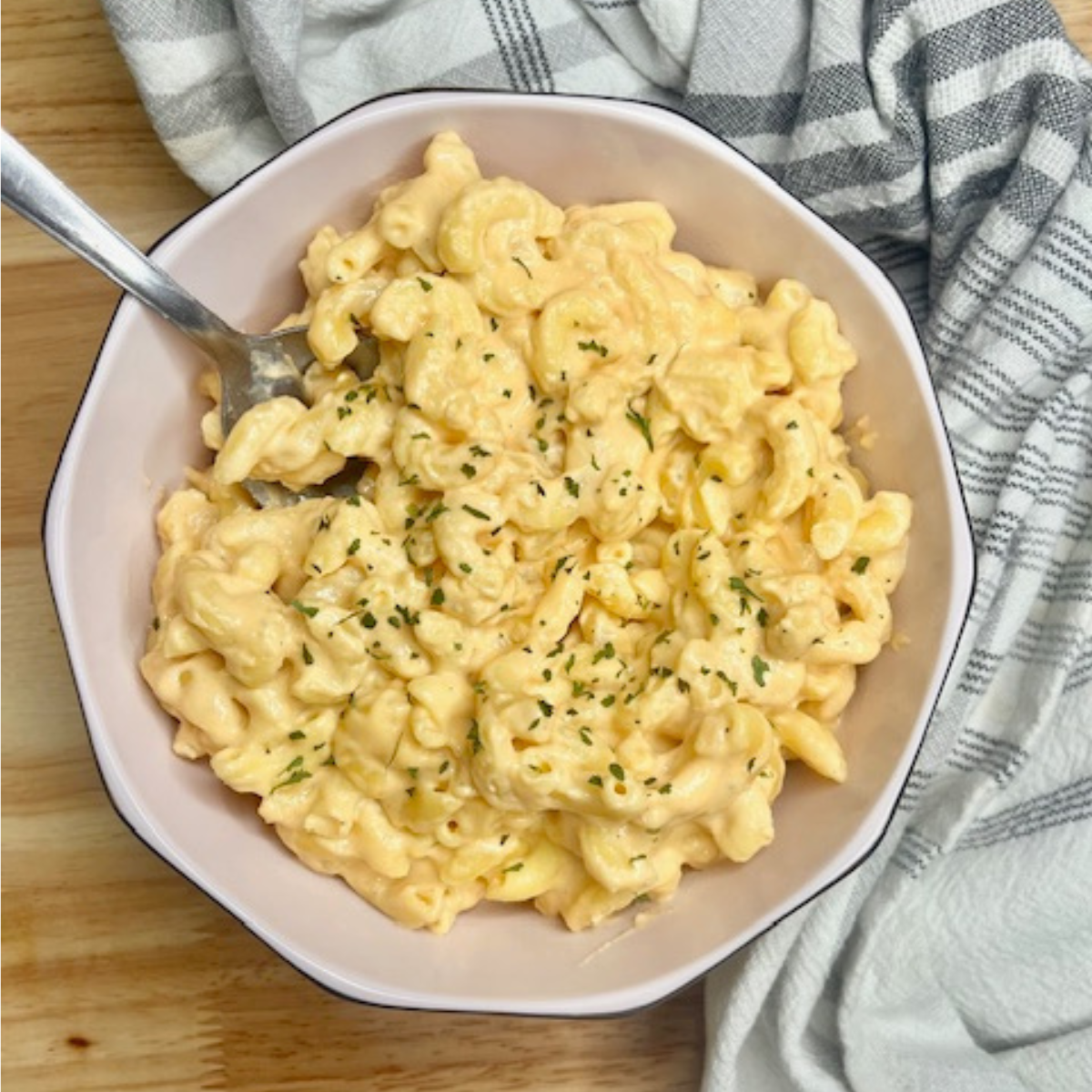 Overhead image of Slow Cooker Mac and Cheese in a light pink bowl