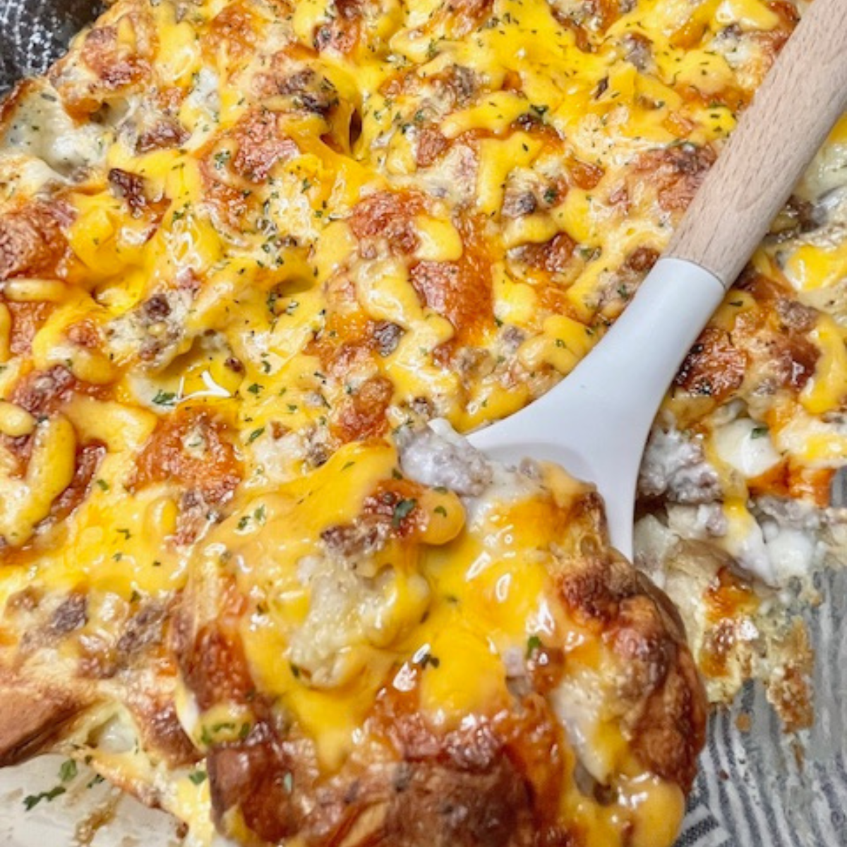 Biscuit and Gravy Casserole being served with a silicone spoon