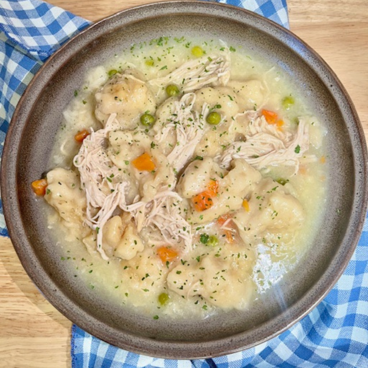 Overhead image of Slow Cooker Chicken and Dumplings in a brown bowl