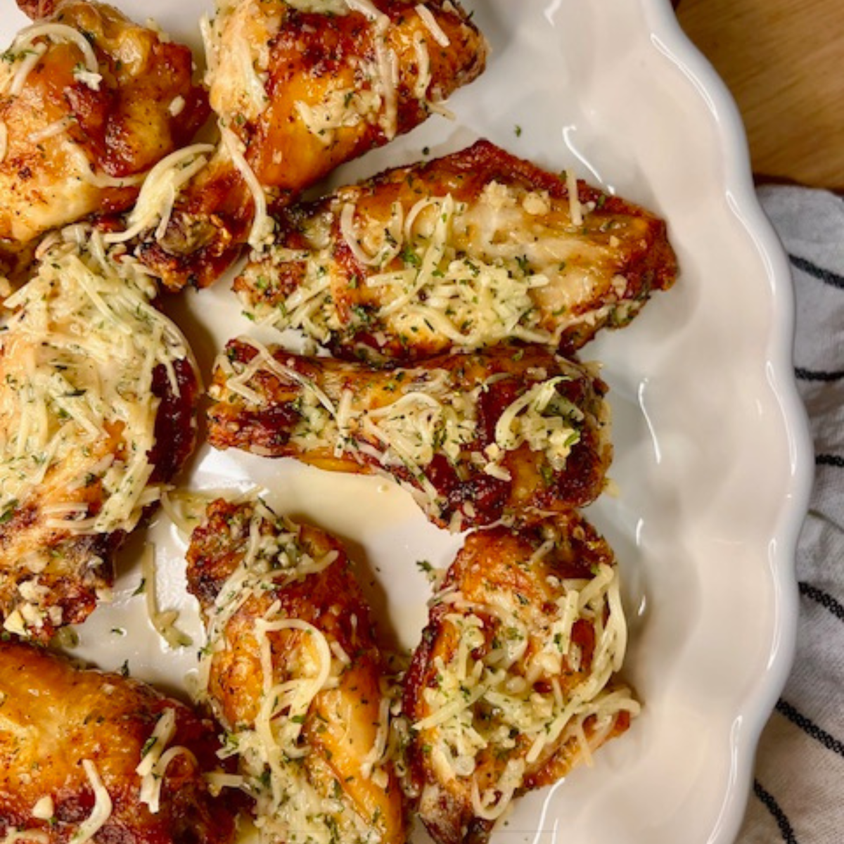 Overhead image of air fryer garlic parmesan wings on a white platter