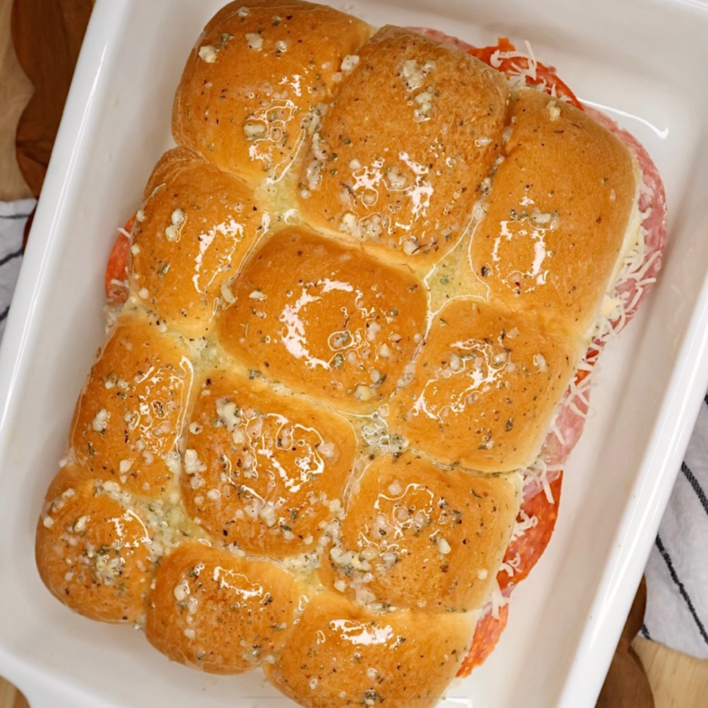 Overhead image of Hawaiian Roll Sliders brushed with butter and herb mixture