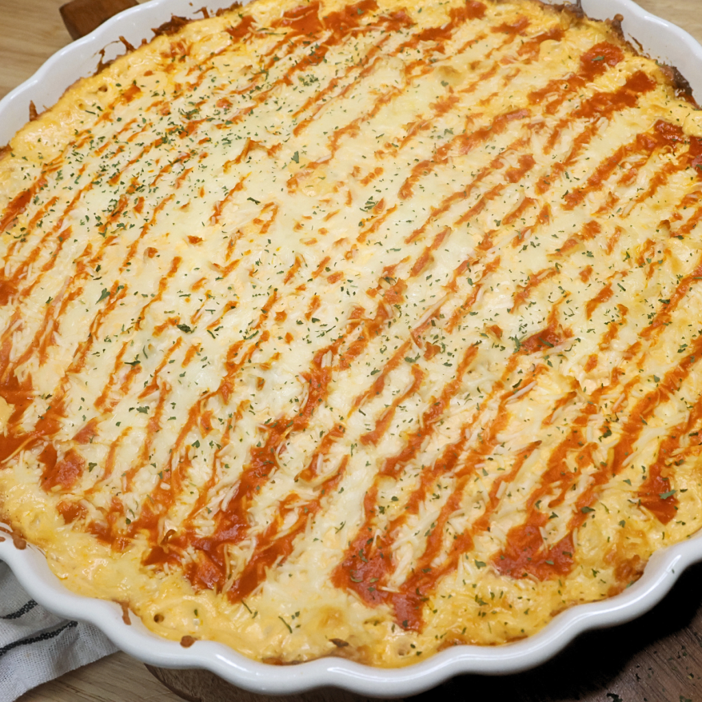 Close up image of buffalo chicken dip with Frank's Redhot 