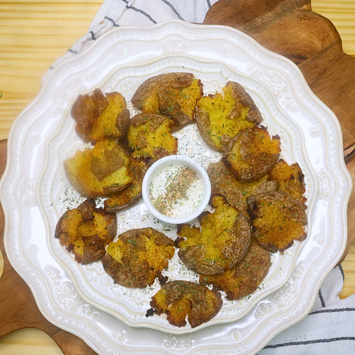 Overhead image of Crispy Cajun Smashed Potatoes on a plate with ranch dressing