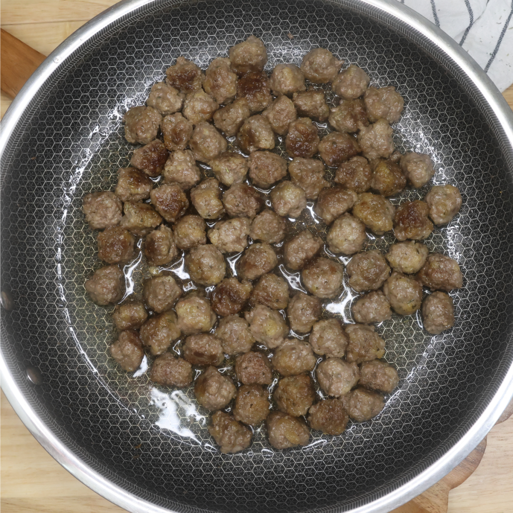 Cooked mini meatballs in a skillet