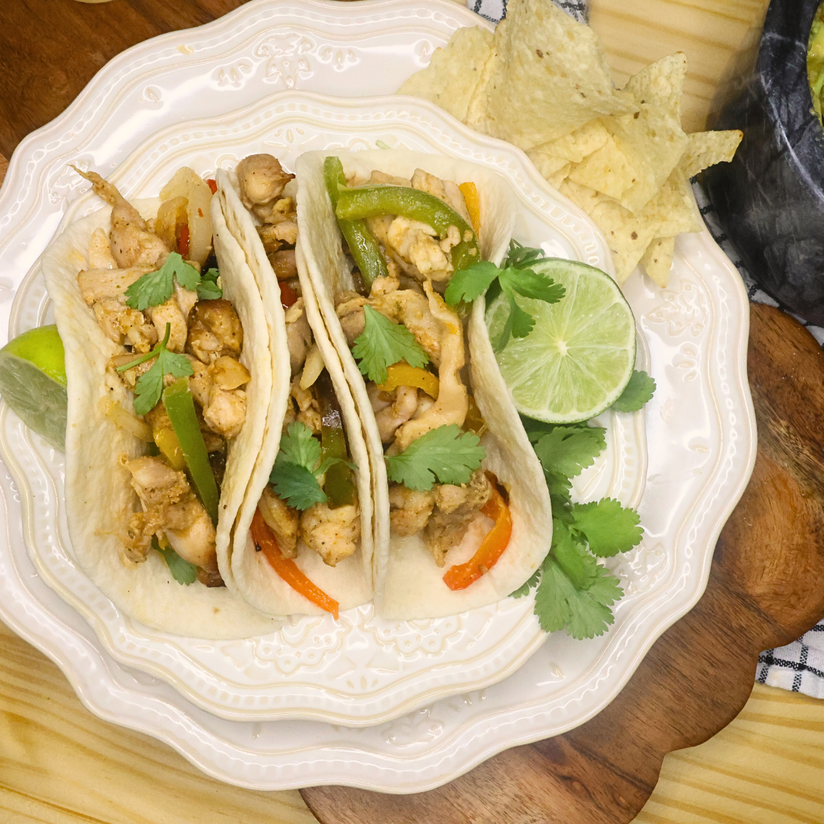 Overhead image of three air fryer chicken fajitas on a plate