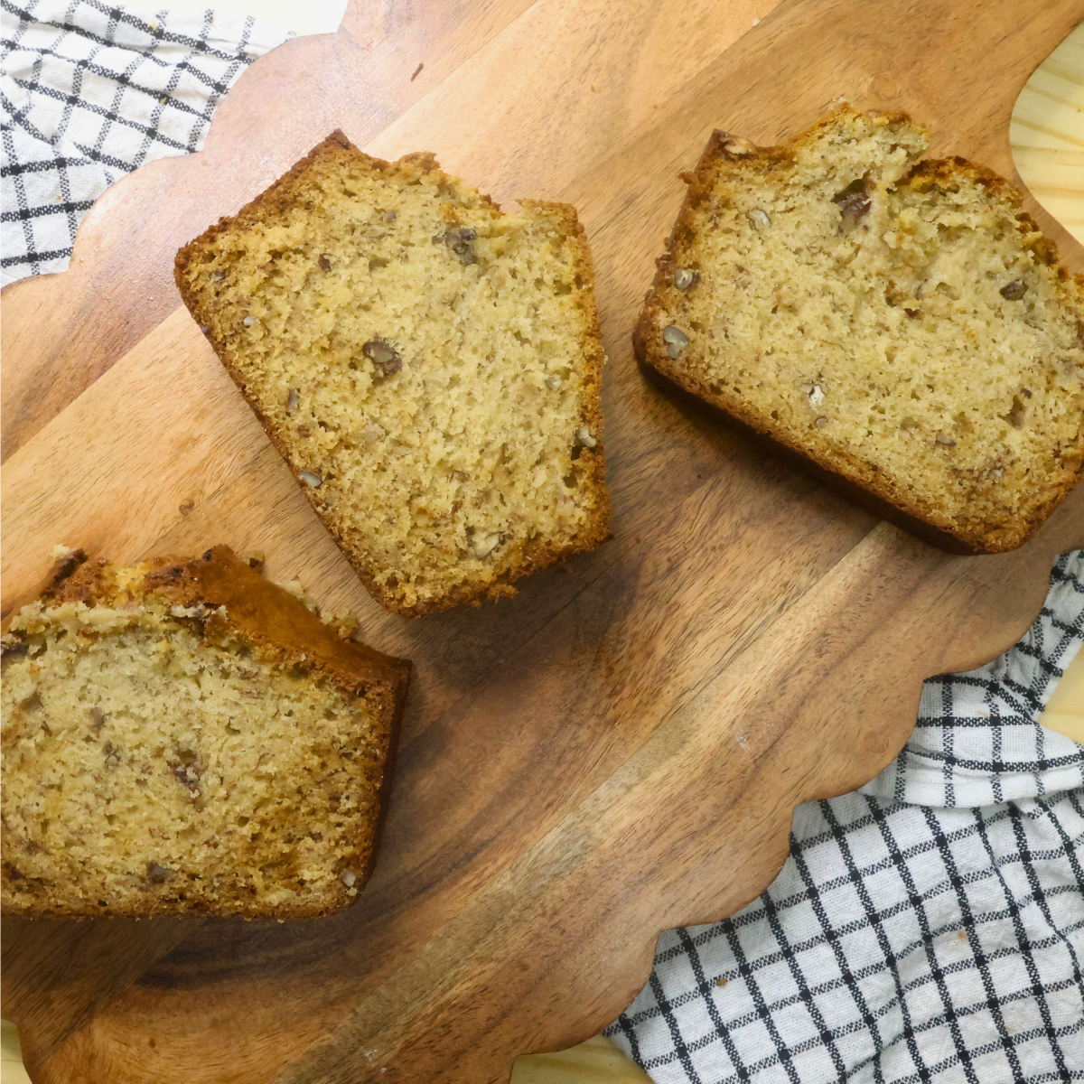 Three slices of banana bread on a wooden serving platter