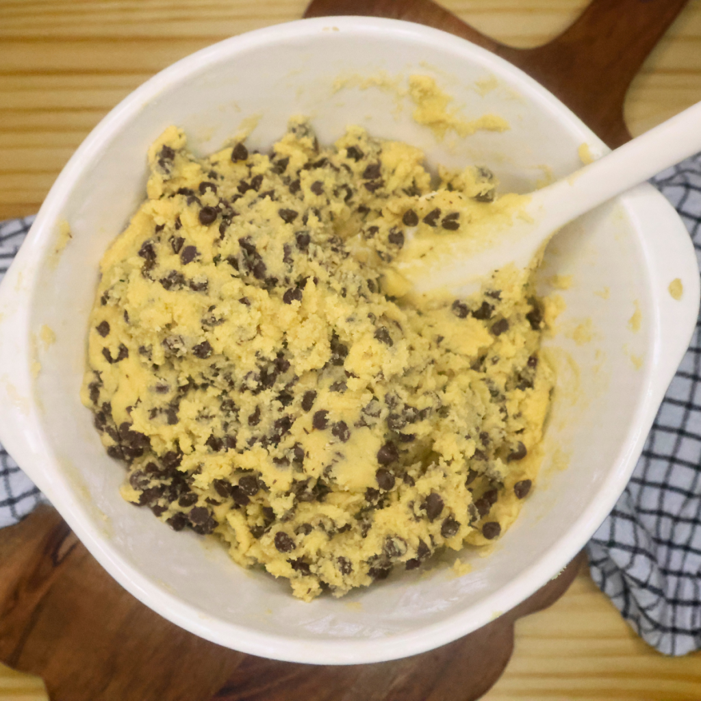 cookie dough for thin chocolate chip cookies in a mixing bowl