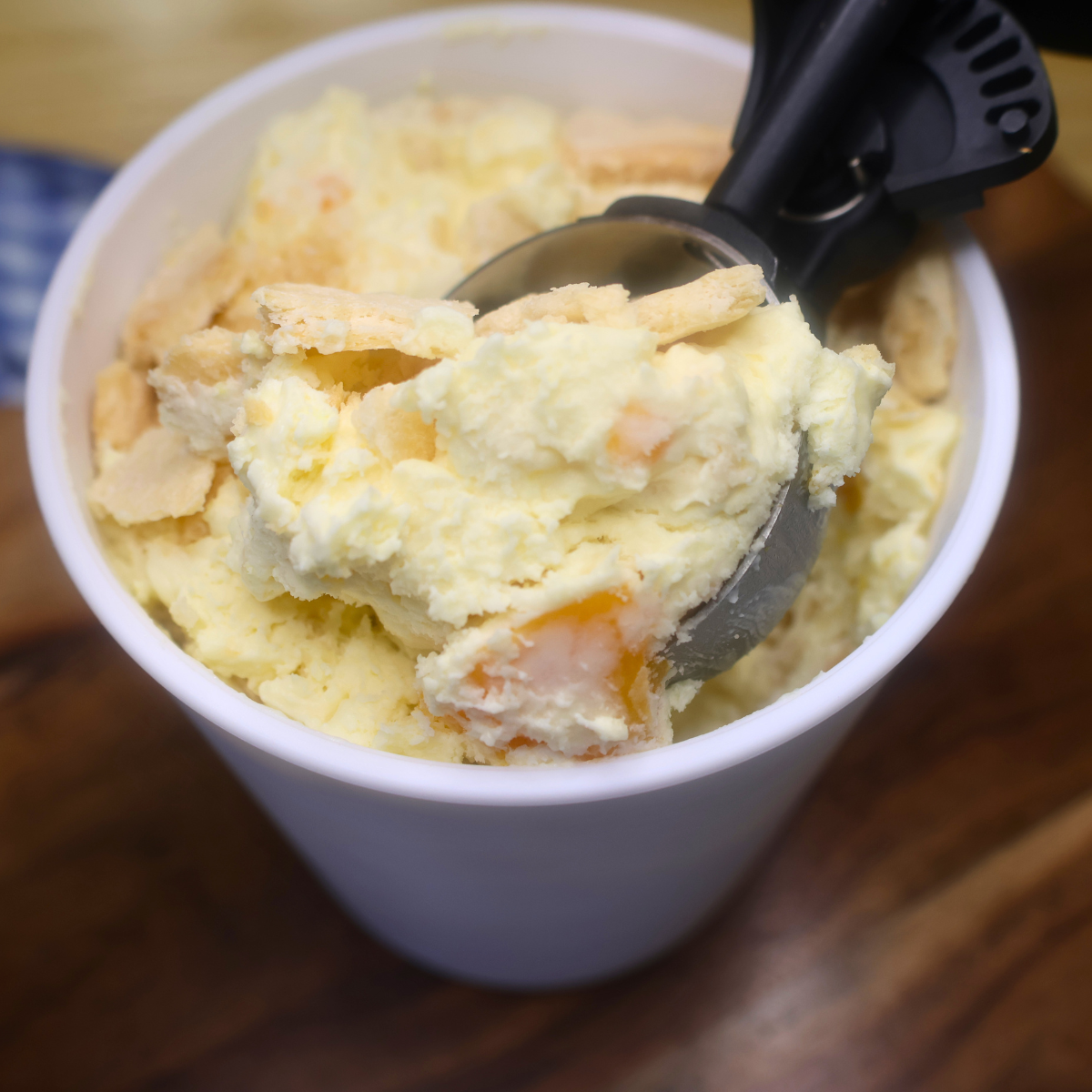 No Churn Peach Cobbler Ice Cream being scooped out of an ice cream container