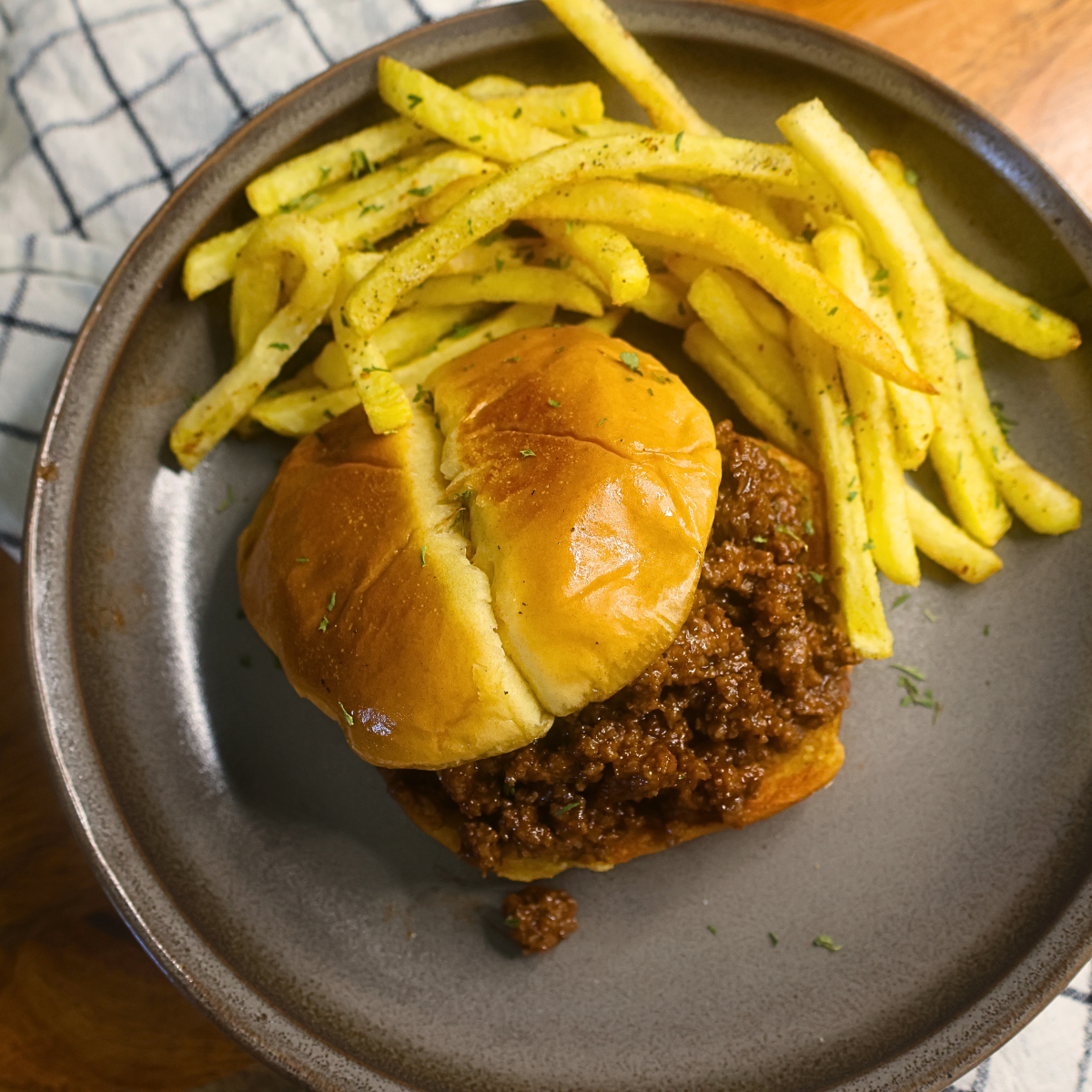 Overhead image of BBQ Crumble Burgers on a plate with french fries