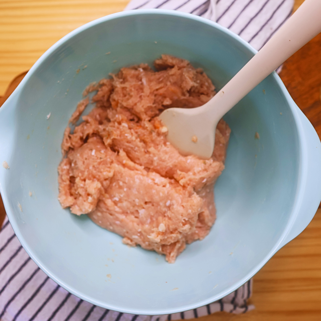 Ground chicken in a bowl with seasoning