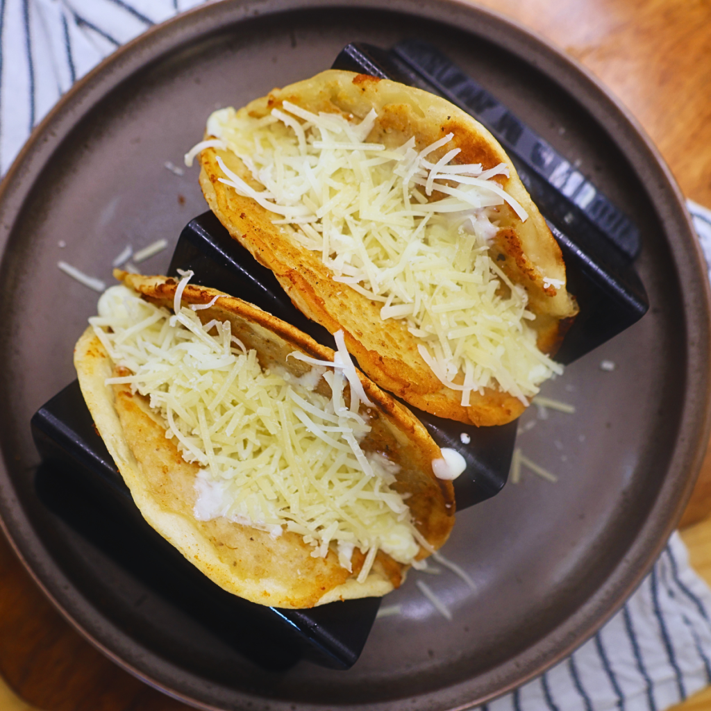 Chicken Smash Tacos with homemade alfredo sauce and shredded parmesan and mozzarella cheese