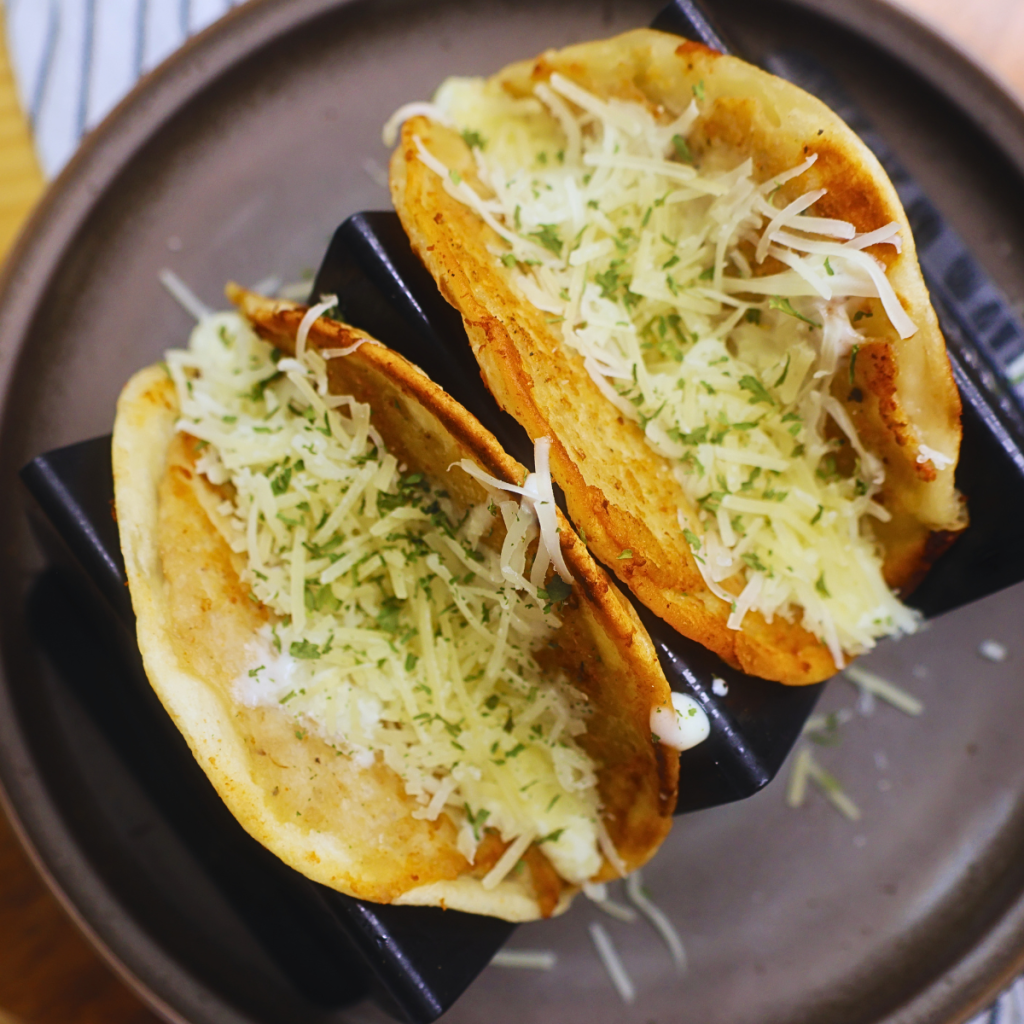 Two Chicken Alfredo Smash Tacos on a taco holder