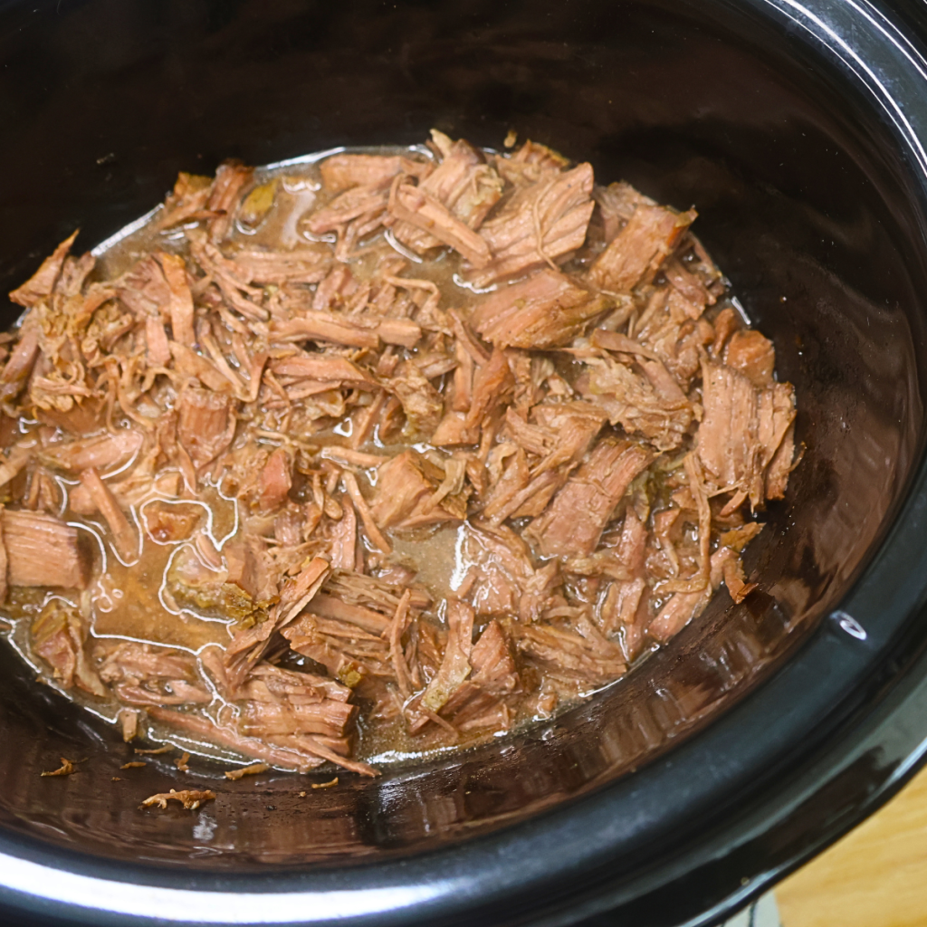 Pulled beef with juices in a slow cooker